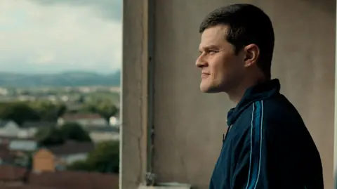Studio Canal A photo from the film of the actor on the balcony of a high flat looking out