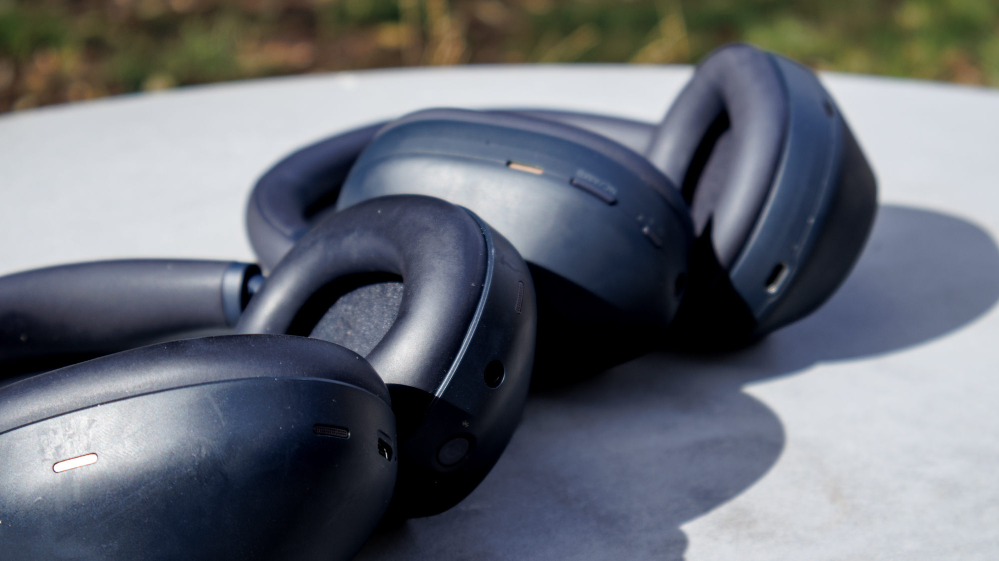 The Sony WH-1000XM5 and XM6 on a table outside