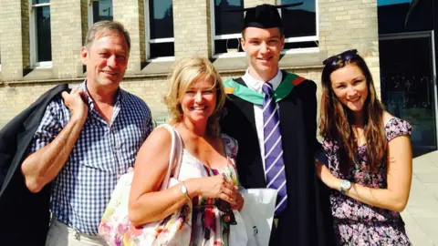 Family handout The Wilson's family smiling for the camera on Tom's graduation - with his father, mother and sister.