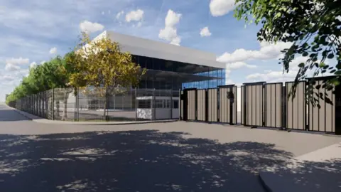 Nscale A graphic of what the AI centre will look like. It is a glass building with a white roof. It is surrounded by fencing and trees line its side. There is a road on the other side of the fences.