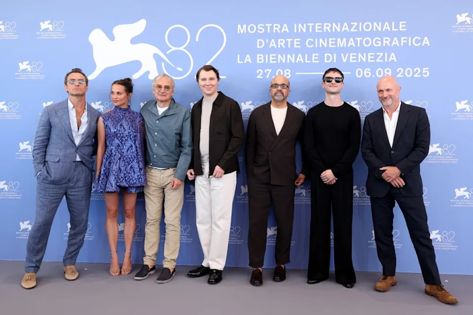Jude Law, Alicia Vikander, Olivier Assayas, Paul Dano, Jeffrey Wright, Tom Sturridge, and Will Keen attend “The Wizard Of The Kremlin” (Le Mage Du Kremlin) photocall during the 82nd Venice International Film Festival on August 31, 2025. WireImage