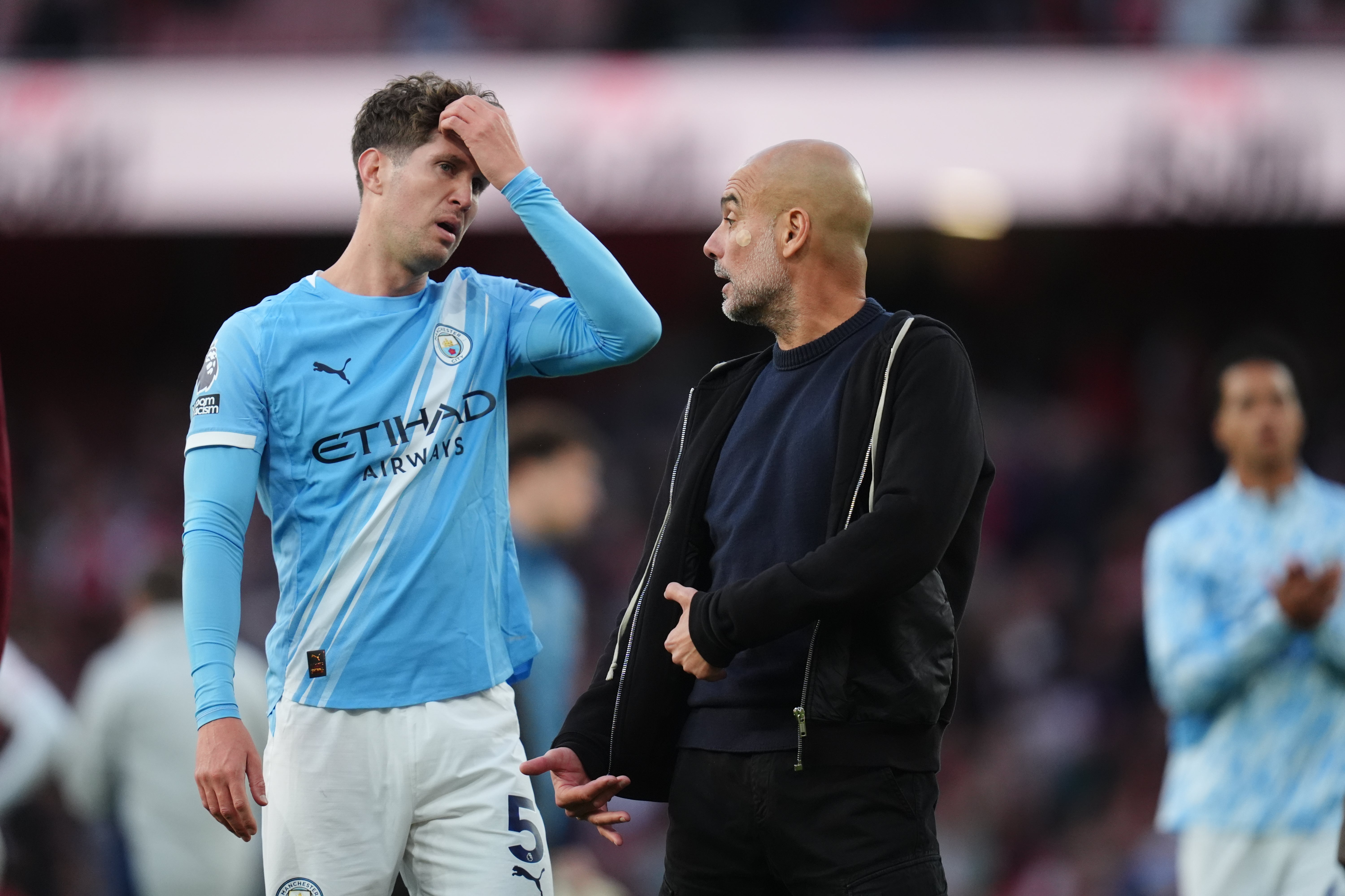 Pep Guardiola in discussion with John Stones at full-time