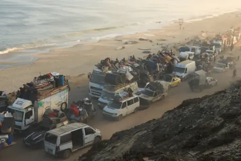 Reuters Displaced Palestinians, fleeing northern Gaza, move southward in cars, trucks and on bikes