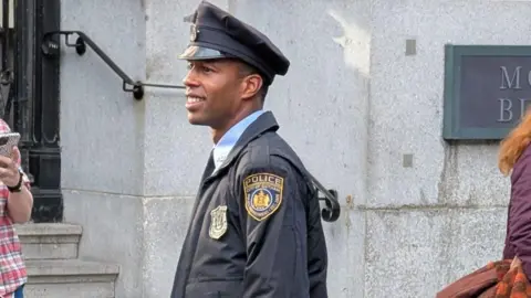 Conor McReynolds An actor on set dressed in a City of Gotham Police uniform