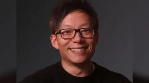 James Lim James Lim wearing a black t shirt and glasses while smiling at the camera. It is a professional photo.