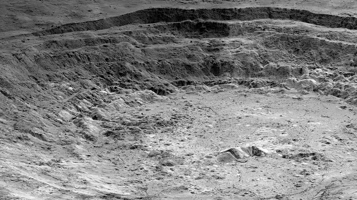 Gravity with an “Edge”: What Lies Beneath Aristarchus Crater