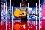Harriet Reed, Curator of Contemporary Performance at the Victoria and Albert Museum (V&A), with late British musician David Bowie’s Ziggy Stardust guitar at the David Bowie Centre in the V&A East Storehouse in London.