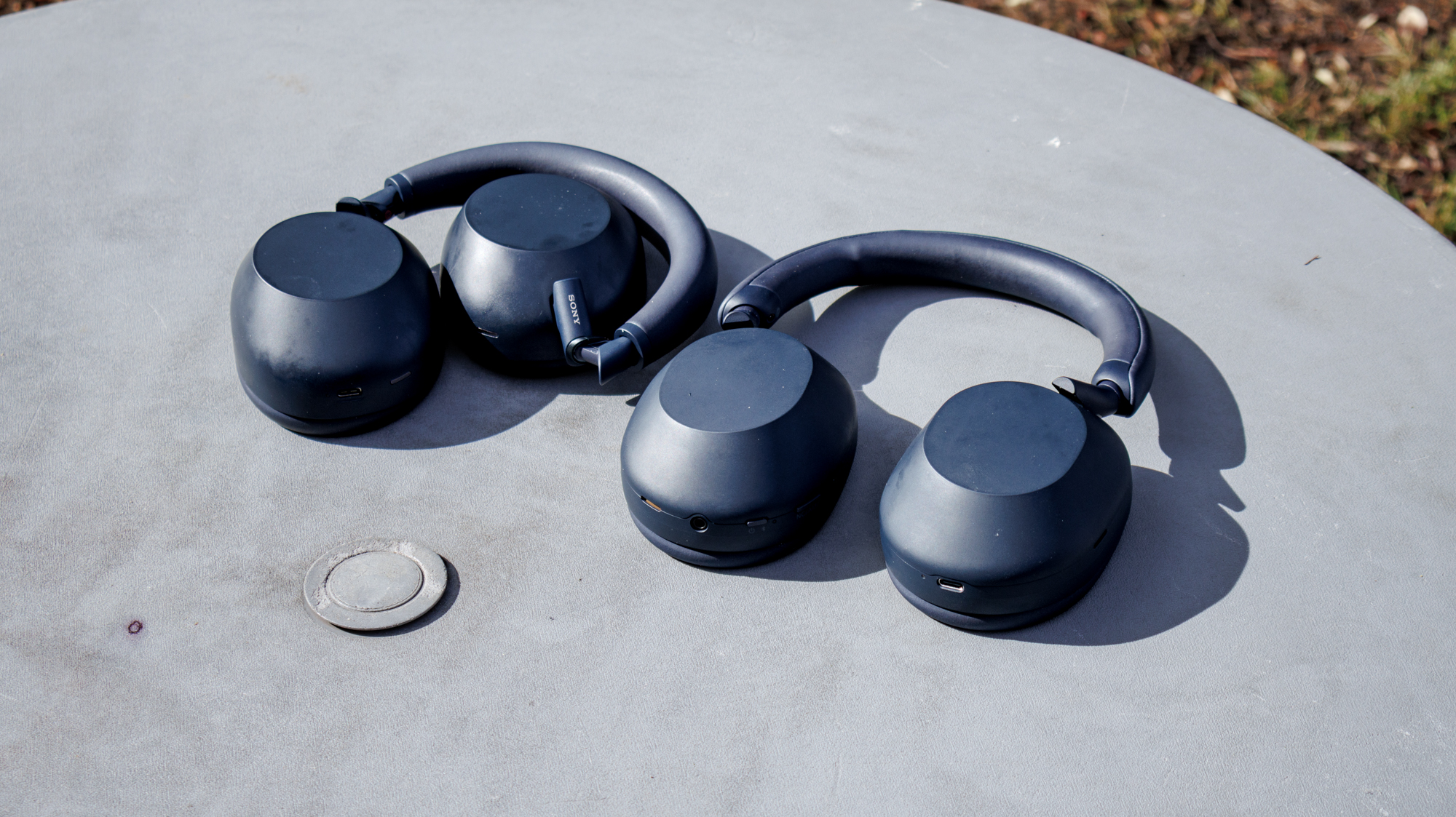 The Sony WH-1000XM5 and XM6 on a table outside