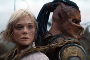 (L-R) Thia (Elle Fanning) and Dek (Dimitrius Schuster-Koloamatangi) in 20th Century Studios' PREDATOR: BADLANDS film. Photo courtesy of 20th Century Studios. © 2025 20th Century Studios. All Rights Reserved.