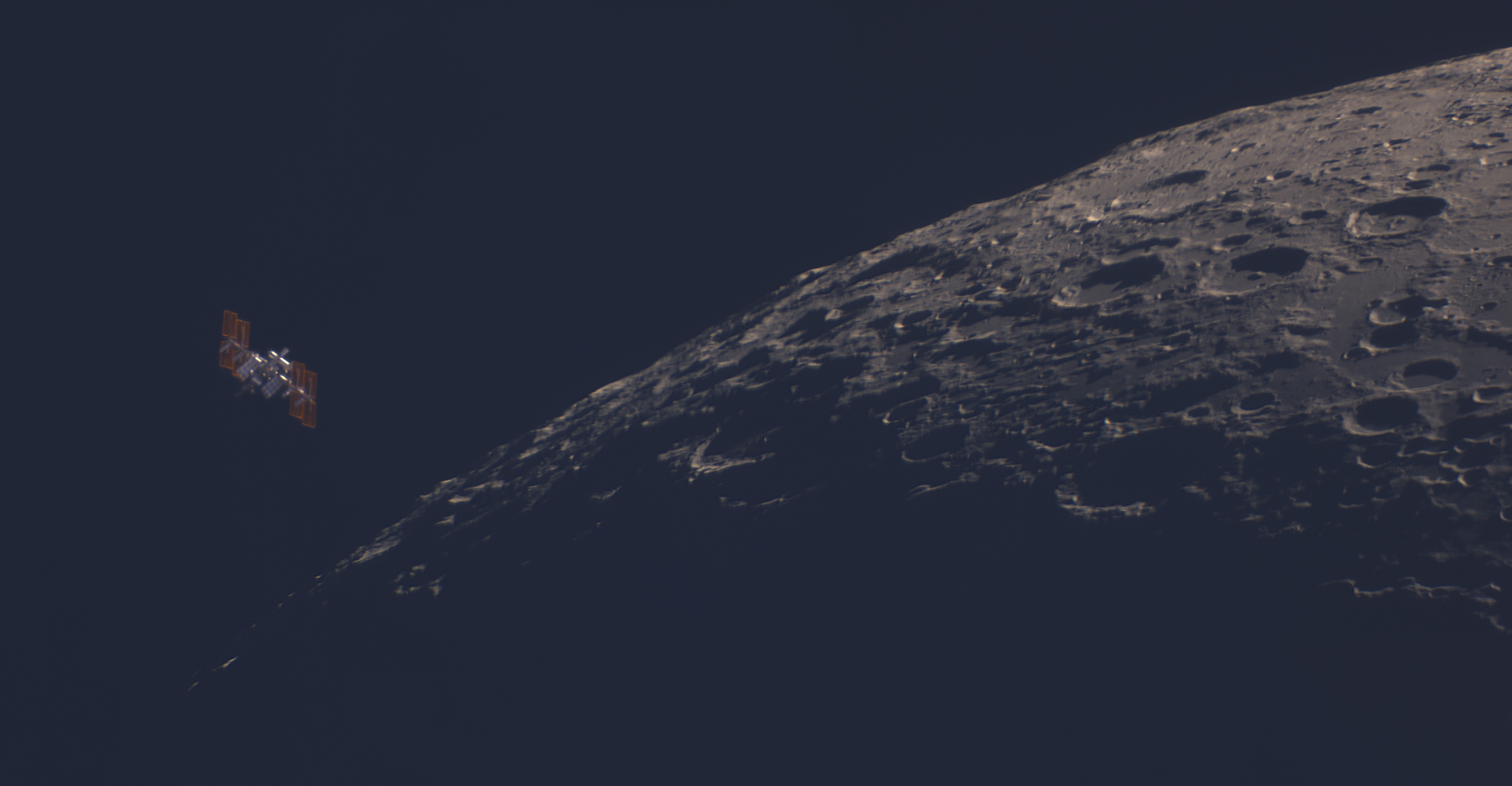 an H-shaped space station shown against a black sky with the cratered form of the moon visible to its right.