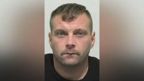 Northumbria Police Mugshot of Gary Chitticks. He has very faint stubble and short hair hair shaved at the sides.