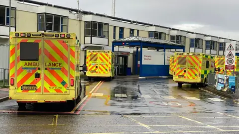 Jill Bennett/BBC A series of ambulances outside the Queen Elizabeth Hospital in King's Lynn emergency department.