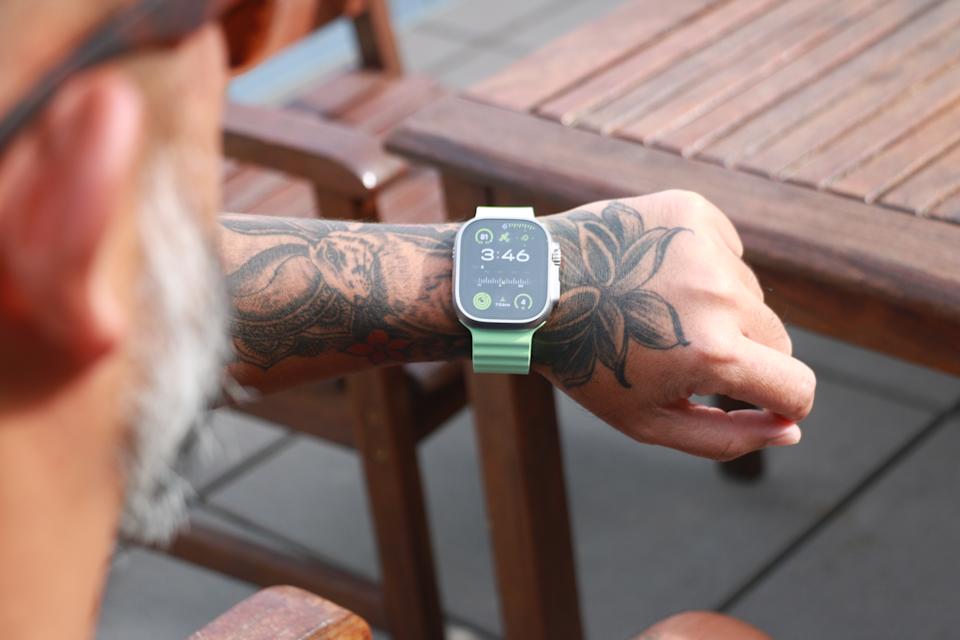 The Apple Watch Ultra 3 on a person's wrist, showing the Modular watch face on its screen.