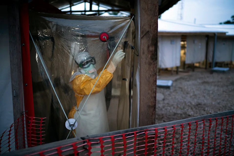 A health worker wearing protective suit enters an isolation pod to treat a patient at a treatment center in Beni, Democratic Republic of Congo