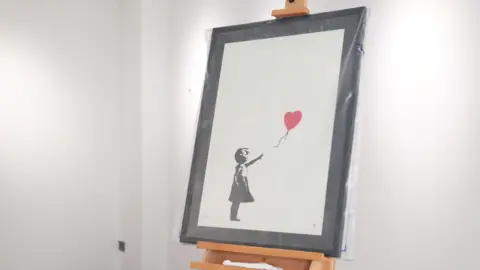 PA Media A drawing of a young girl in black ink. She stretches out an arm and appears to have let go of a red balloon on a string, which floats into the air.