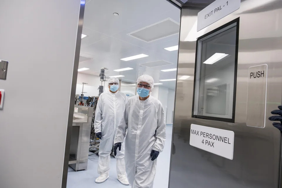 Dharmaraj Sankar, Head of GMP Operations looks on as Mabel Chan, Integrated Services Associated Director exits a drug substance suite at the ACES facility