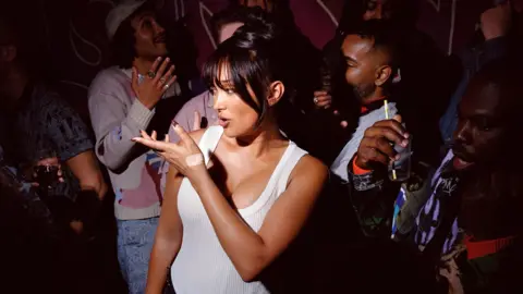 Ewen Spencer A spotlight picks Joy Crookes out of a crowd in a nightclub, in a promo shot for her new album