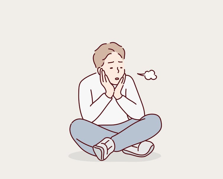 Man sitting on floor sighing