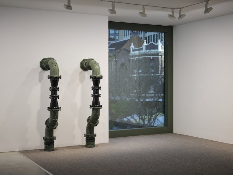 Grey green industrial pipes, window frame, corporate grey carpet