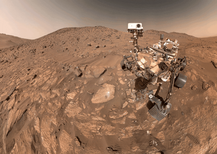 The Perseverance rover on the dusty, rocky Martian surface