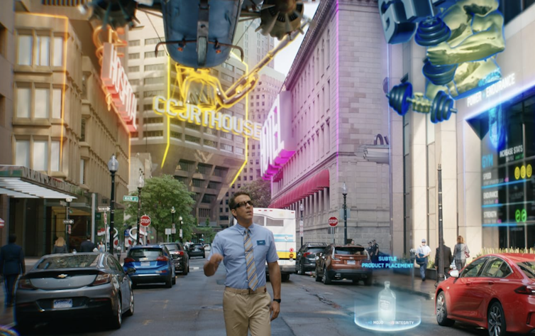 Man walking down the middle of a street while computer-generated flying objects speed by him.