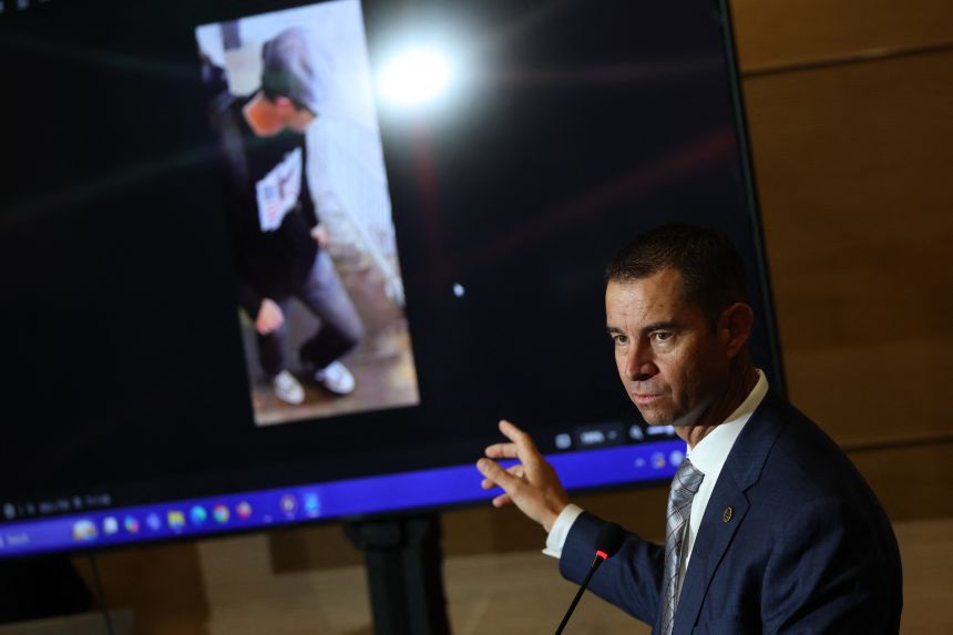 Beau Mason, of the Utah Department of Public Safety, points to a photo of a person of interest as he speaks during a press conference at Utah Valley University a day after youth activist and influencer Charlie Kirk was shot.