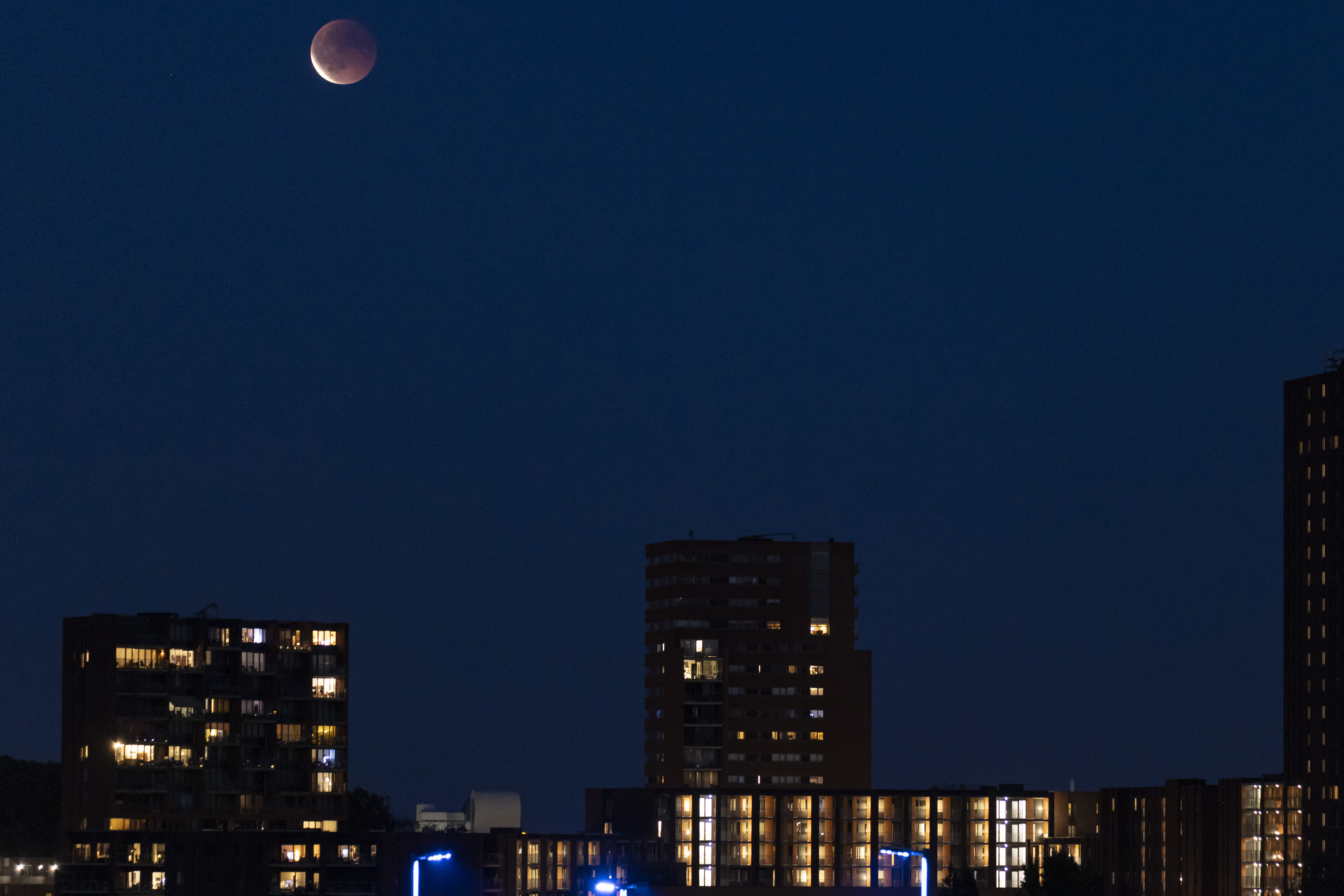 A photograph of the "blood moon" above residential buildings in Eindhoven, the Netherlands