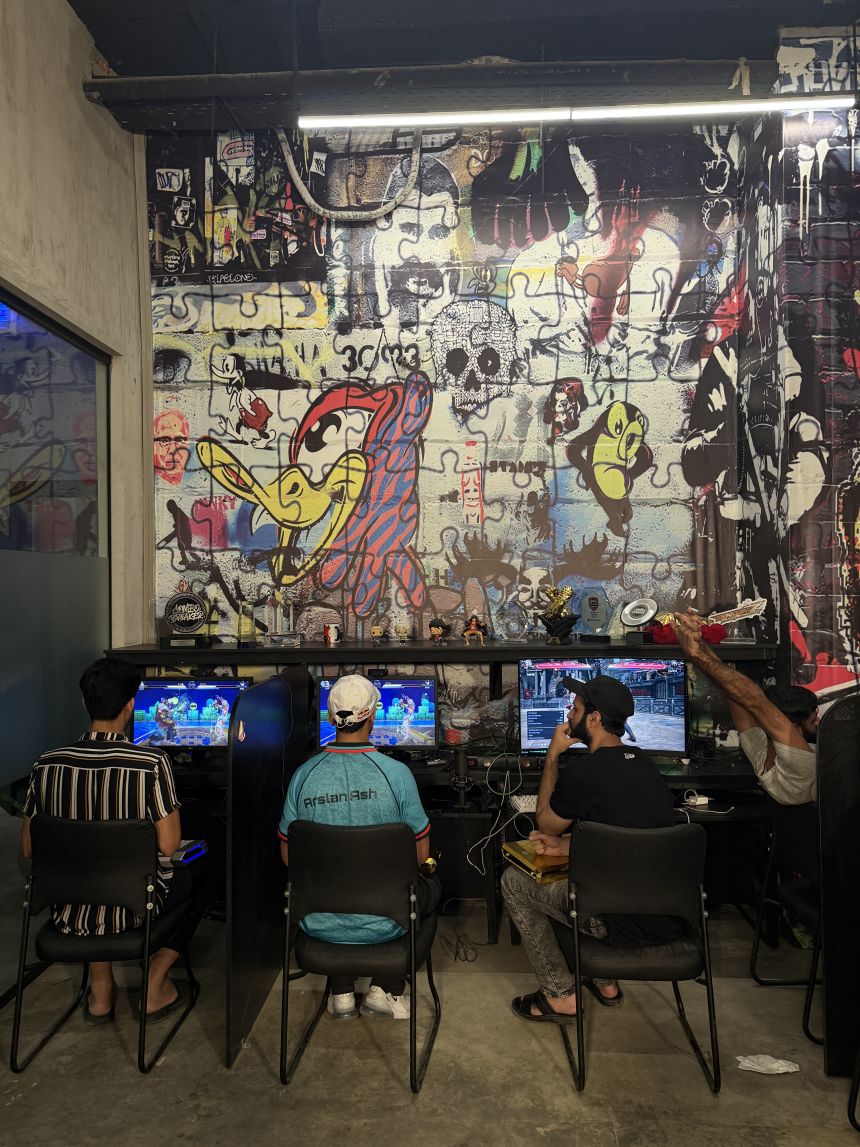Arsalan “Ash” Siddique, center, practices at the Maniax arcade.