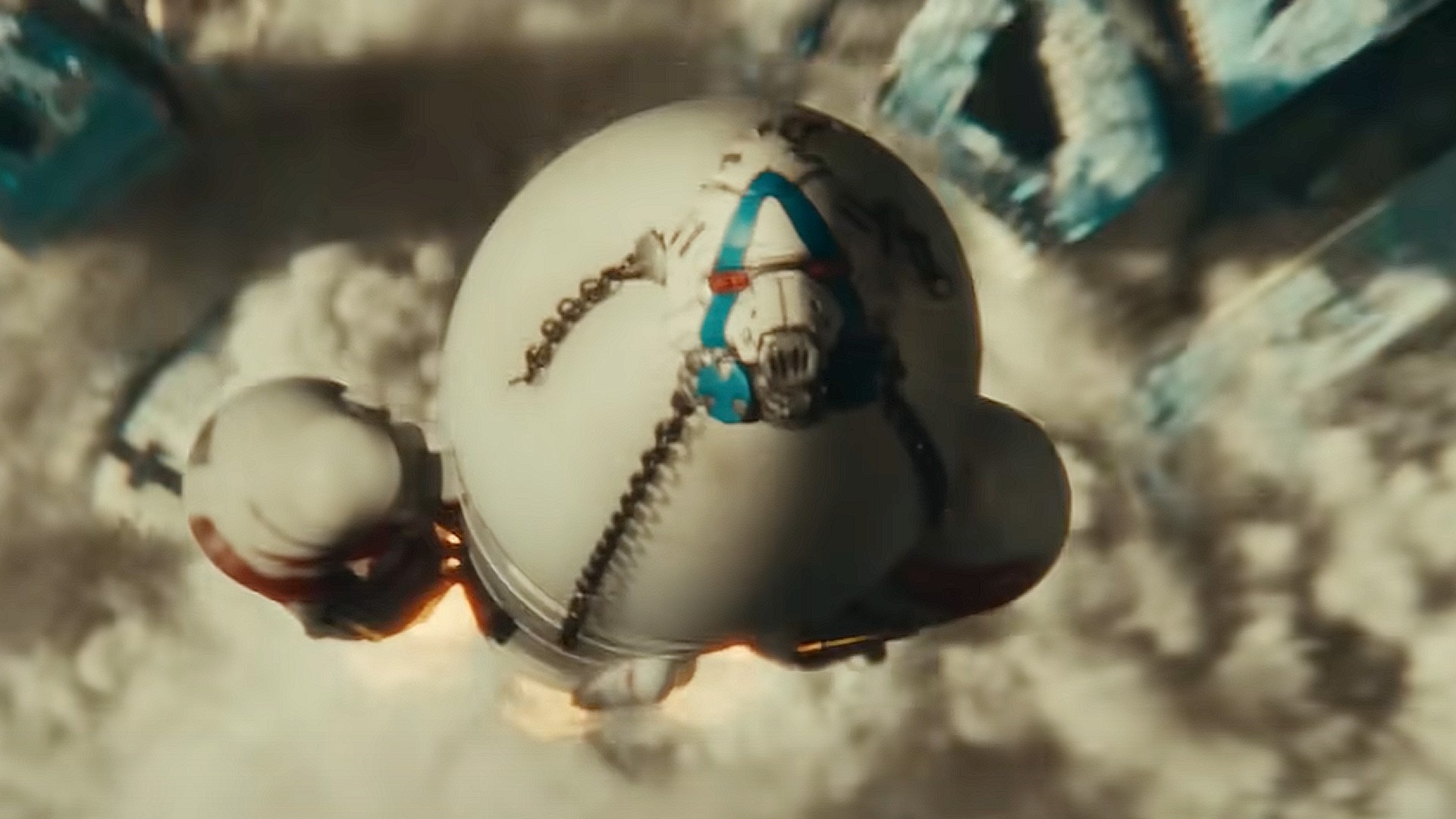 a large rocket looms in the distance behind a bus with the words "Quit Earth" on it