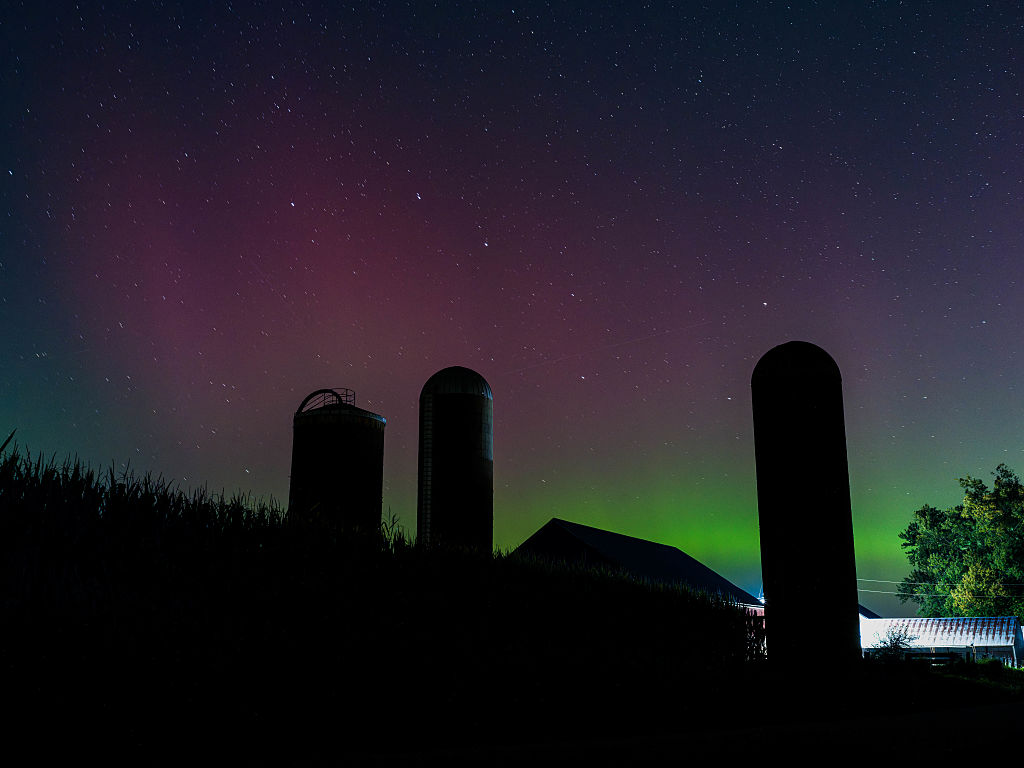 northern lights above southern wisconsin appearing as curtains and pillars of magenta and green light. 