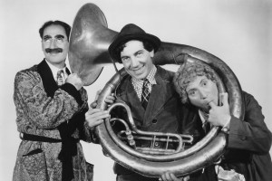 The Marx Brothers Groucho, Chico and Harpo pose with a tuba from the 1937 film 'A Day at the Races'.