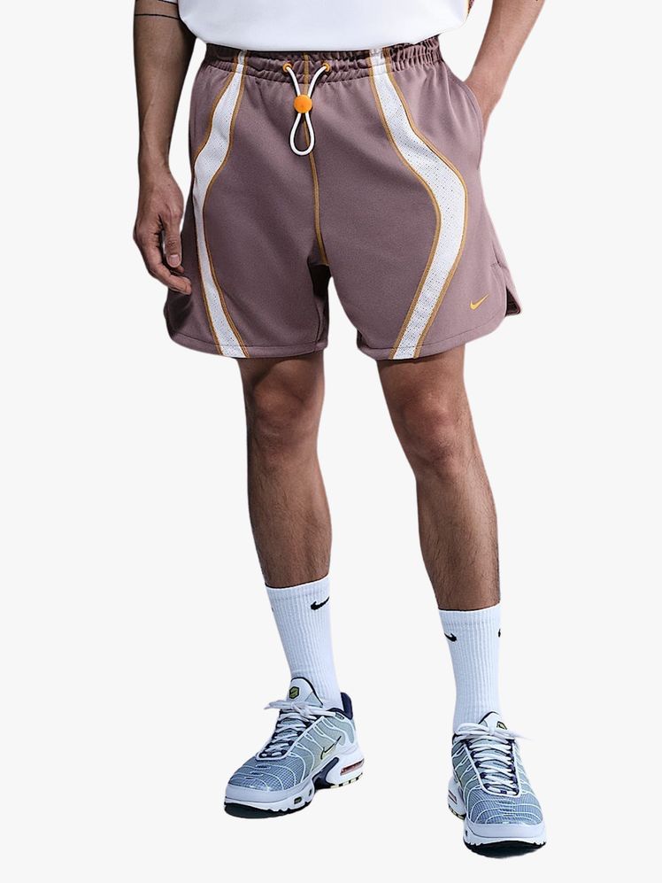 Model wearing workout shorts on a flat background.