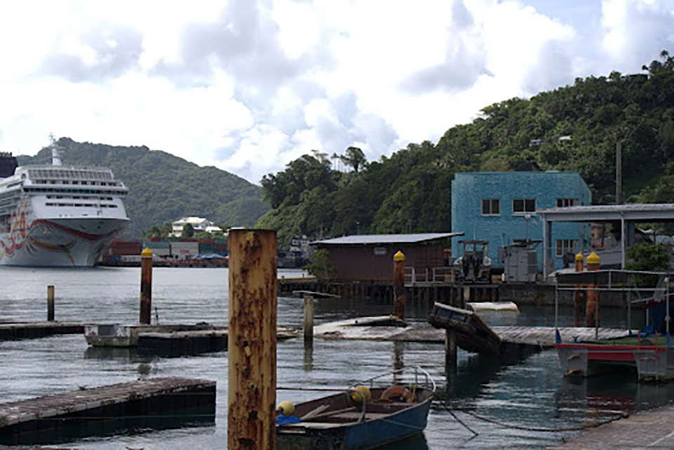 Floating piers in a harbor are broken and partially submerged following a tsunami.