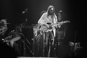 Canadian singer-songwriter Neil Young performing with The Santa Monica Flyers at the Rainbow Theatre, London, 5th November 1973. Ralph Molina is on drums (left). (Photo by Michael Putland/Getty Images)