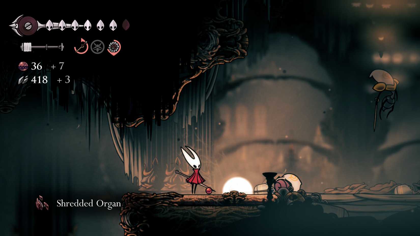 Hornet collecting a shredded organ in Silksong