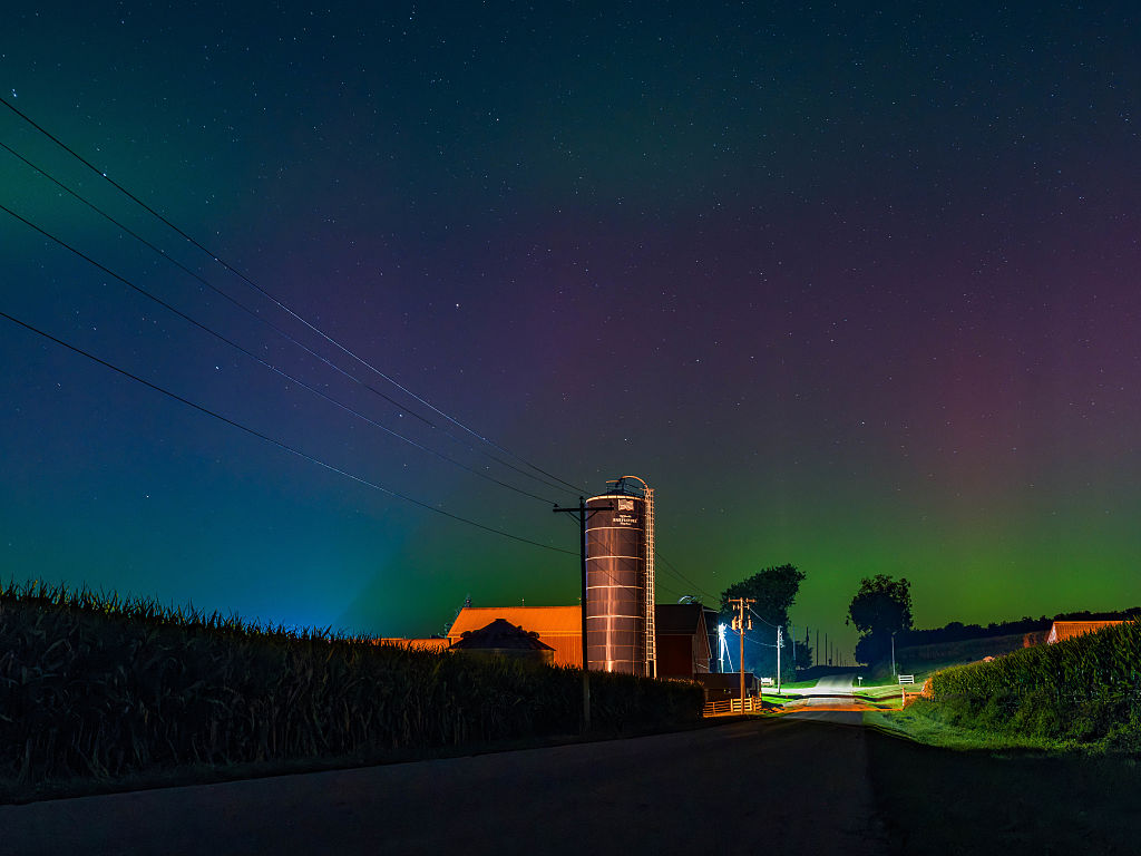 northern lights above southern wisconsin appearing as curtains and pillars of magenta and green light. 