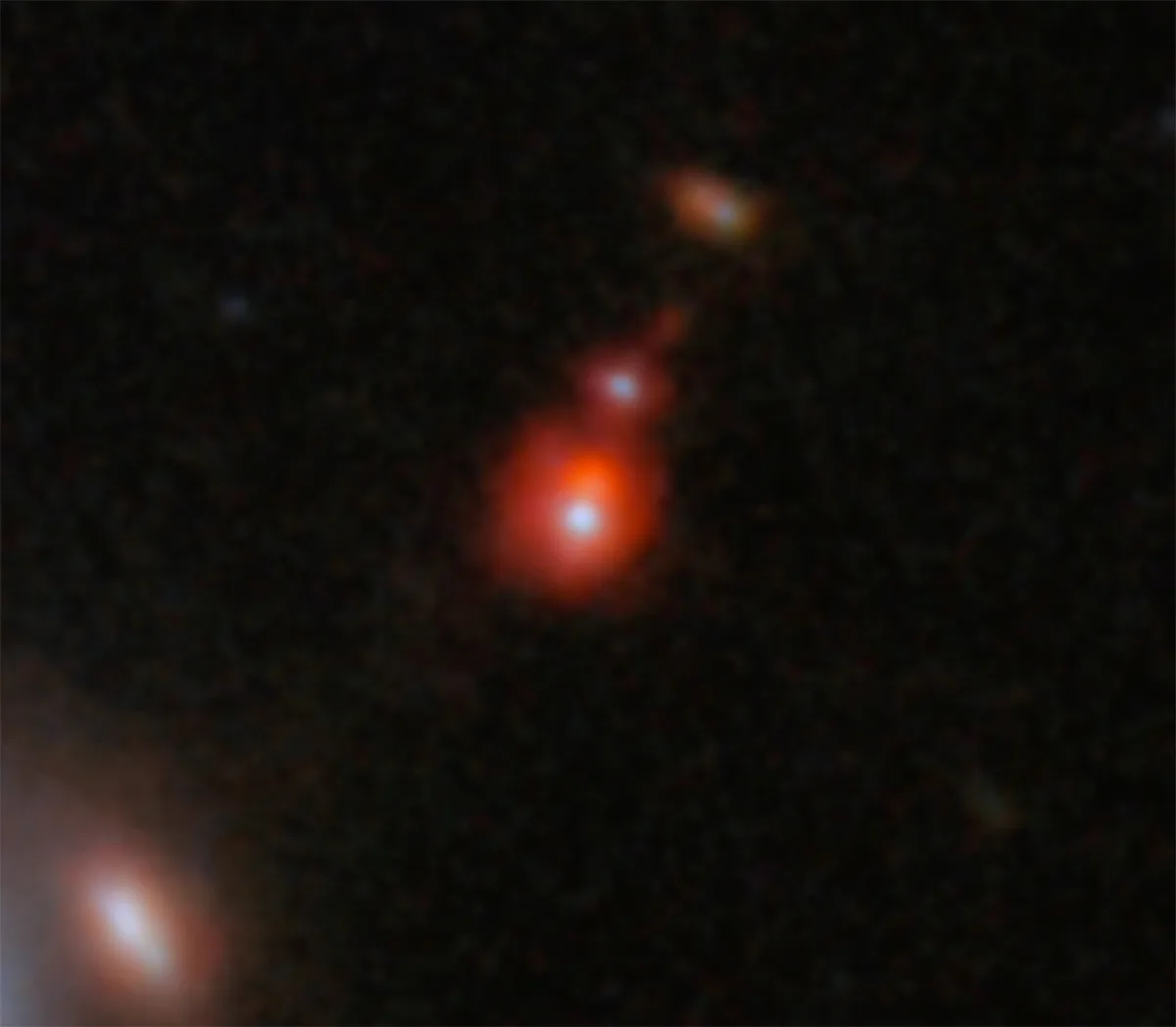 Image showing galaxy system ZS7, location of the farthest black hole collision ever seen. Credit: ESA/Webb, NASA, CSA, J. Dunlop, D. Magee, P. G. Pérez-González, H. Übler, R. Maiolino, et. al