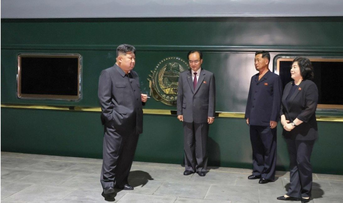Kim Jong Un is seen smoking a cigarette outside the armored train in a photo released by North Korean state media on September 2, as Kim traveled to Beijing.
