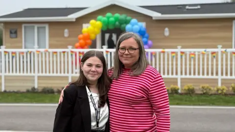 BBC Hannah Roberts standing next to her mother Gail Iredale outside their new respite lodge at Mercia Marina in Willington