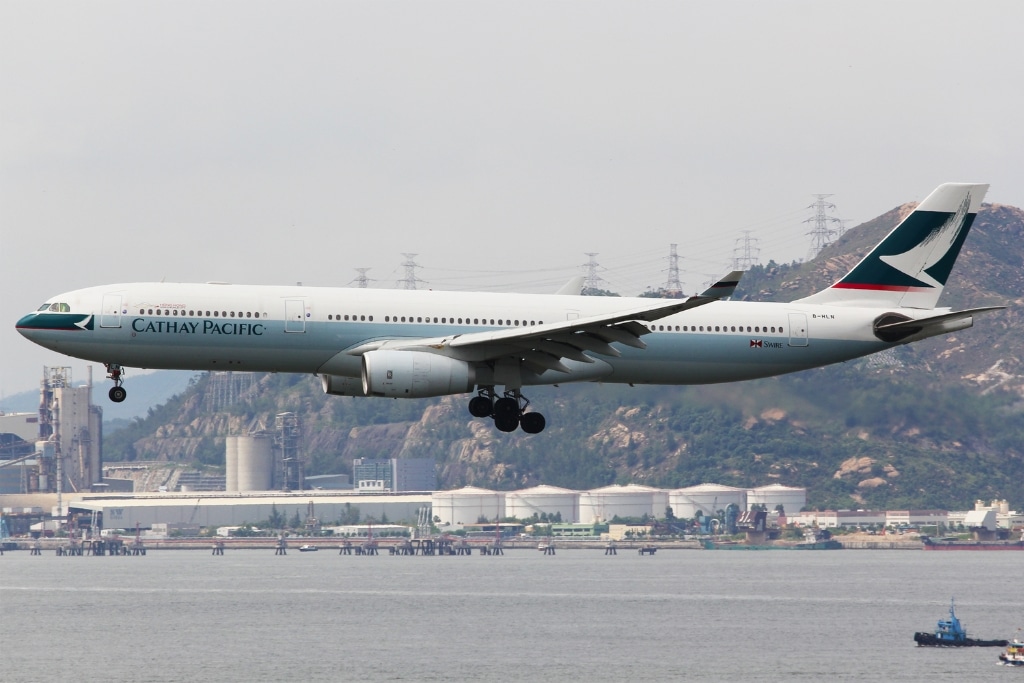 A Cathay Pacific plane approaching the Hong Kong International Airport.