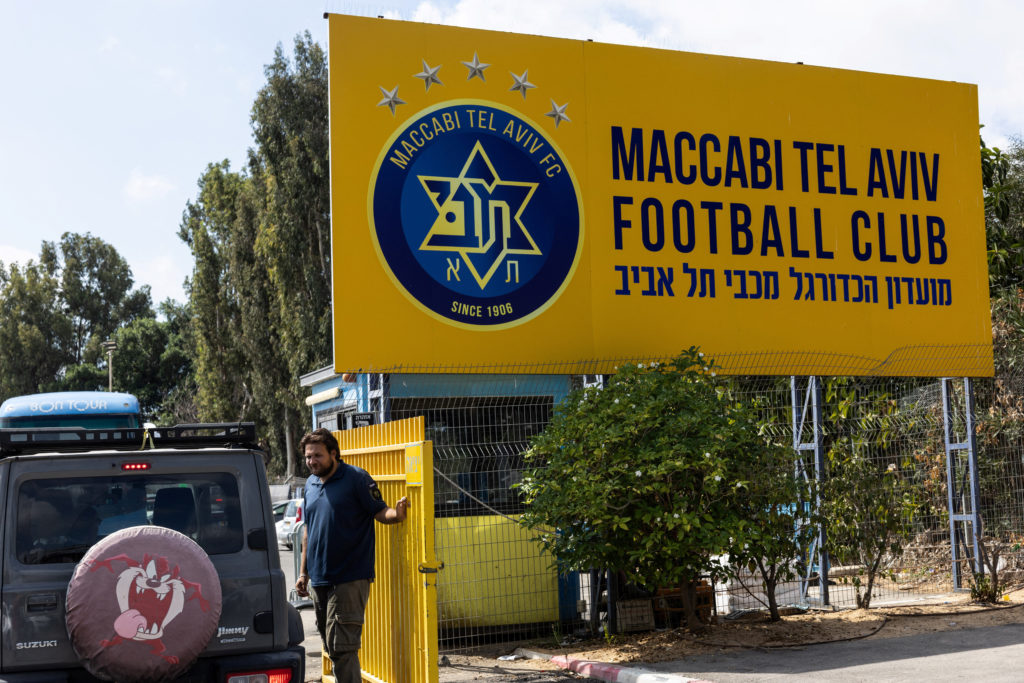 Israeli soccer game abandoned after rioting rival fans throw flares and smoke grenades