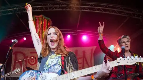 BBC Pictures Rosalie Craig and Tamsin Greig on stage with electric guitars