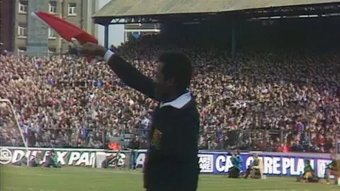Andy Griffith Emerson Griffiths waving a red flag on the pitch in an old photo