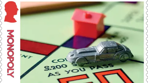 PA Media A close-up of a special edition stamp featuring a Monopoly board with a red house and a metal car.