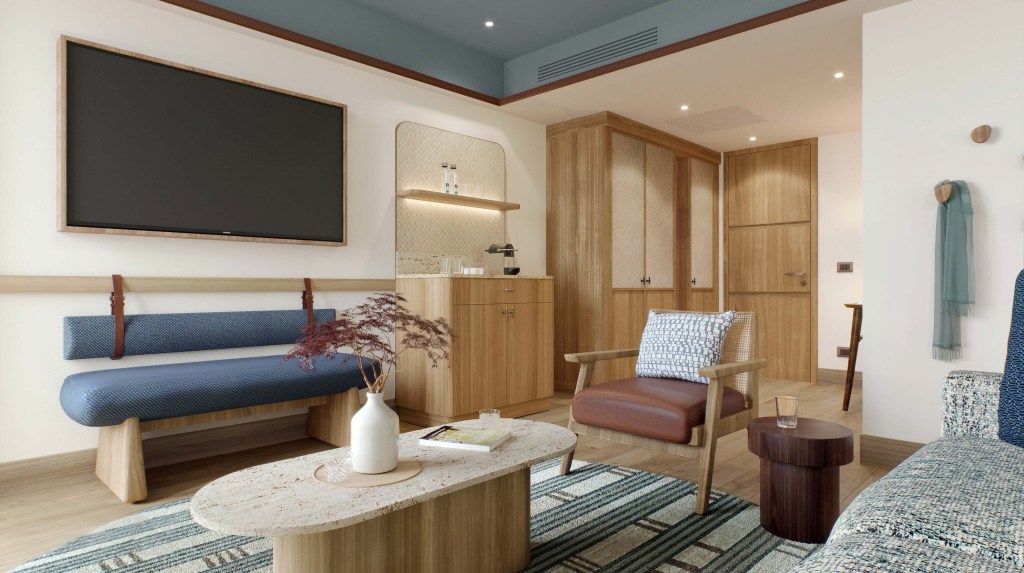 Modern hotel suite with wood accents and seating area.