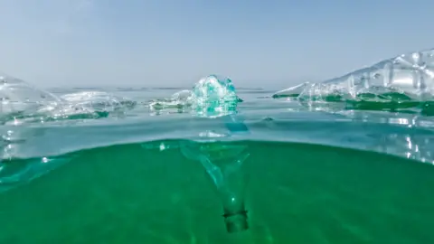 Getty Images Plastic bottles floating in the sea.