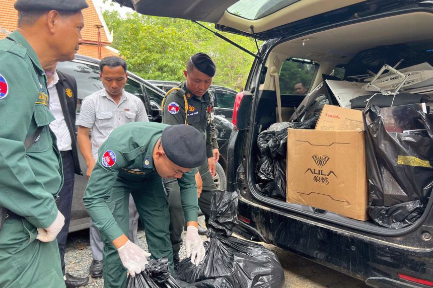 This pool photo taken on July 17, 2025 and released on July 18 by Agence Kampuchea Presse (AKP) shows police checking equipment seized during a raid on a scam center in Kandal province.