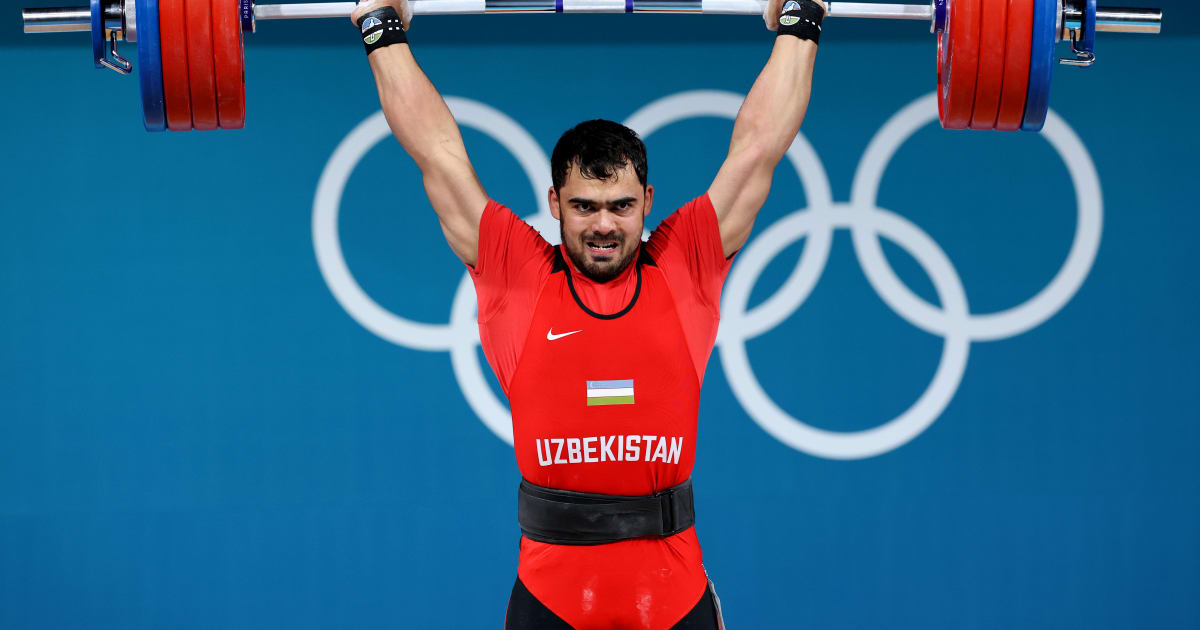 Akbar Djuraev teases the crowd en route to 110kg gold