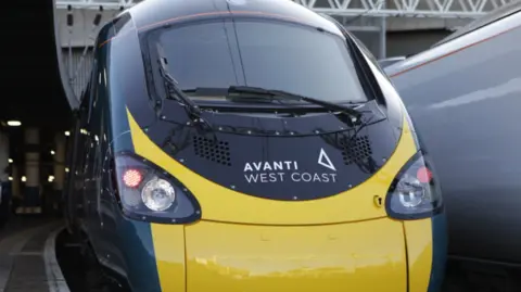 PA Media The front of a train, which is yellow and grey and has the words Avanti West Coast under the window.