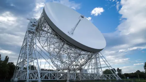 BBC The large white dish of the Jodrell Bank radio telescope.